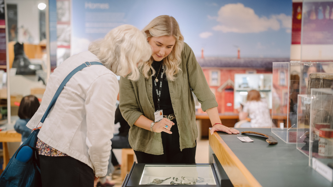 two woman looking at objects in ulster museum 