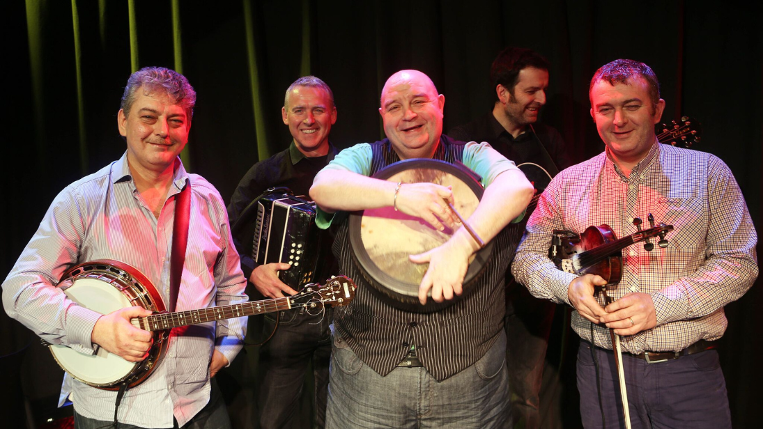 five men who are members of the band four men and a dog
