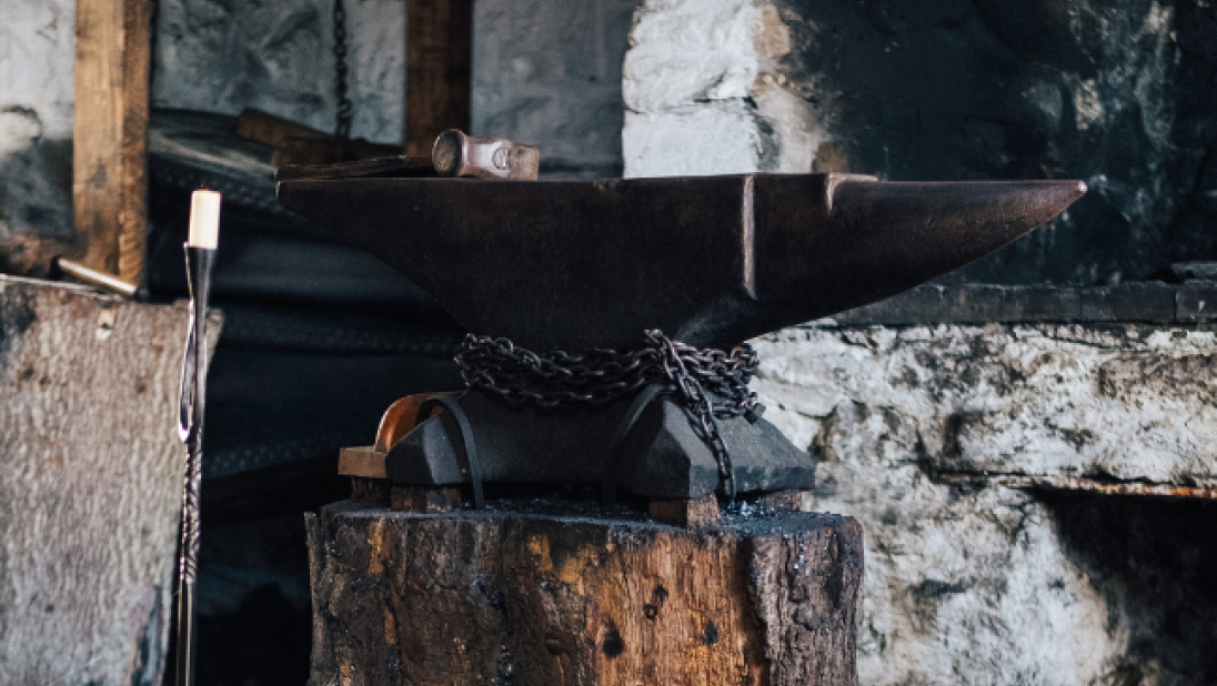 An image of an anvil in a forge.
