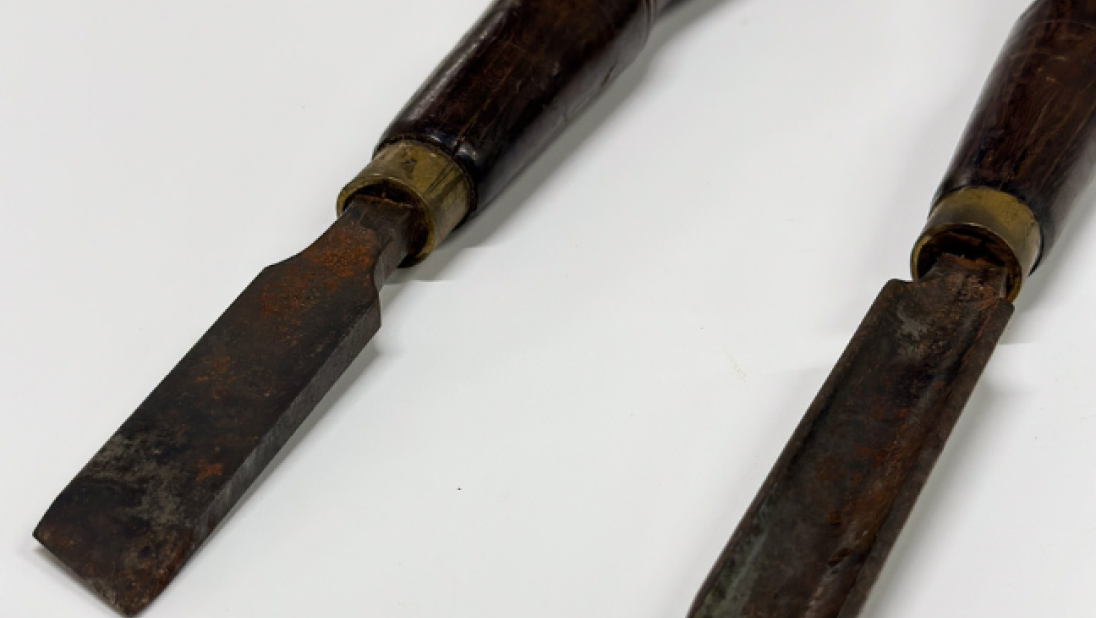 Two chisels lie side by side.