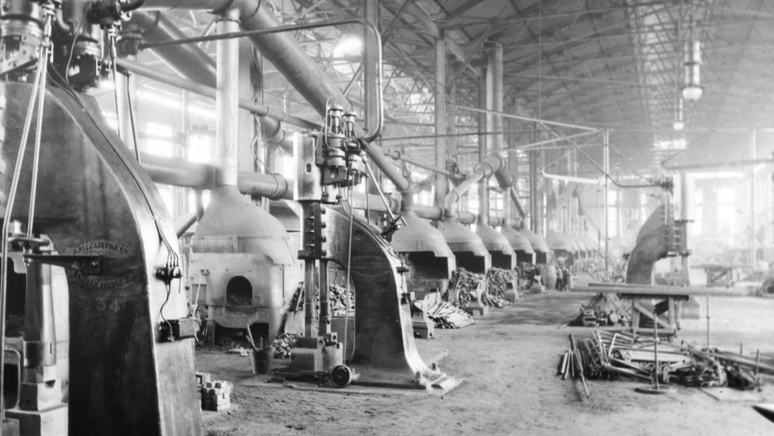 A view of a shipbuilding forge, with many fires going.
