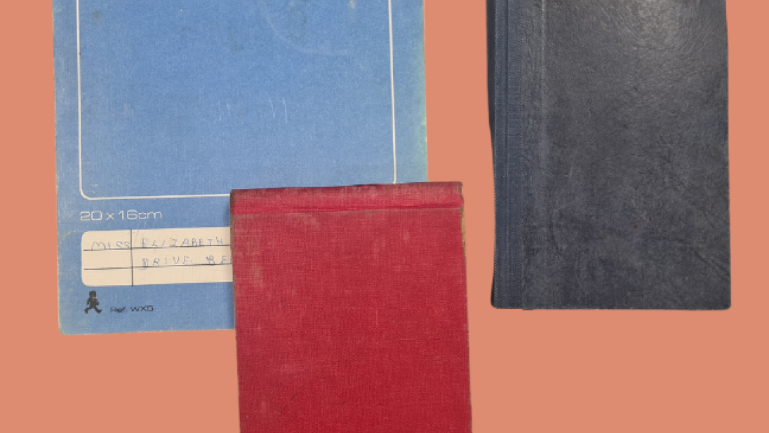 Group of Lily Wright's diaries. One large blue diary, one small red diary and a small black diary.