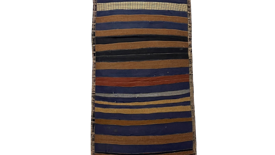 A long rug. It is a striped pattern with different colours of fabric making the stripes.