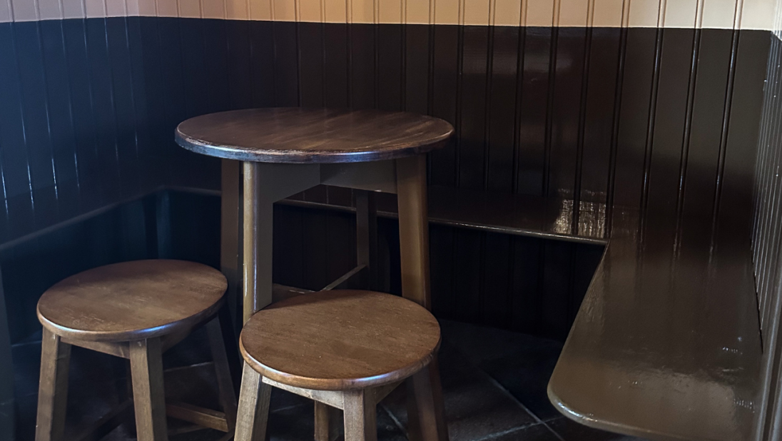 A pub nook with a wooden table and chairs.