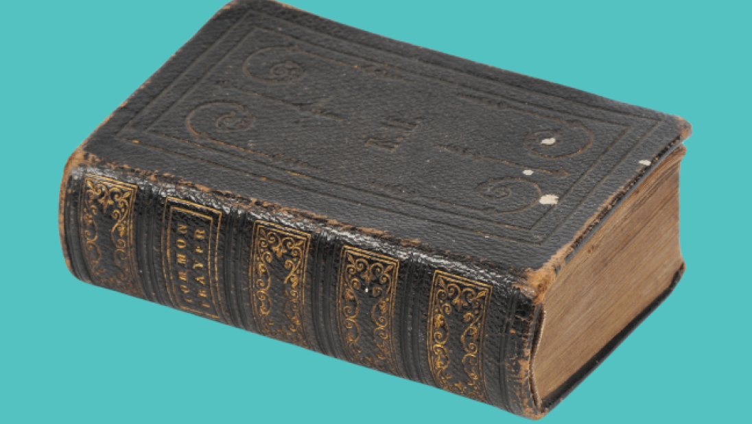Small, used Bible on a turquoise background