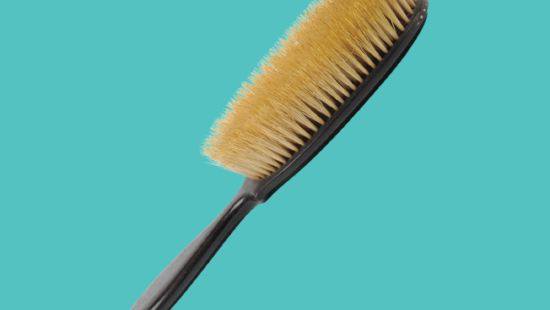 Hair brush on a turquoise background