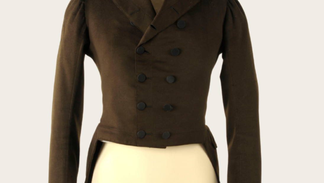 A men's green coat dating from the late 1700s to early 1800s.