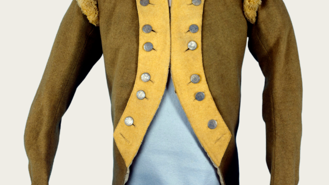 A men's green coat with yellow trim, dating from the late 1700s to early 1800s.