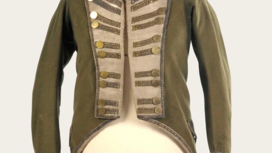 A men's green coat dating from the late 1700s to early 1800s.