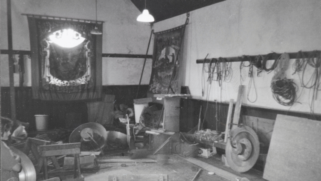 A black and white image of an Orange Order Hall. A banner hangs on the wall.