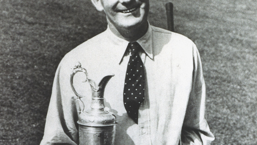 A black and white photograph of Fred Daly holding a trophy.
