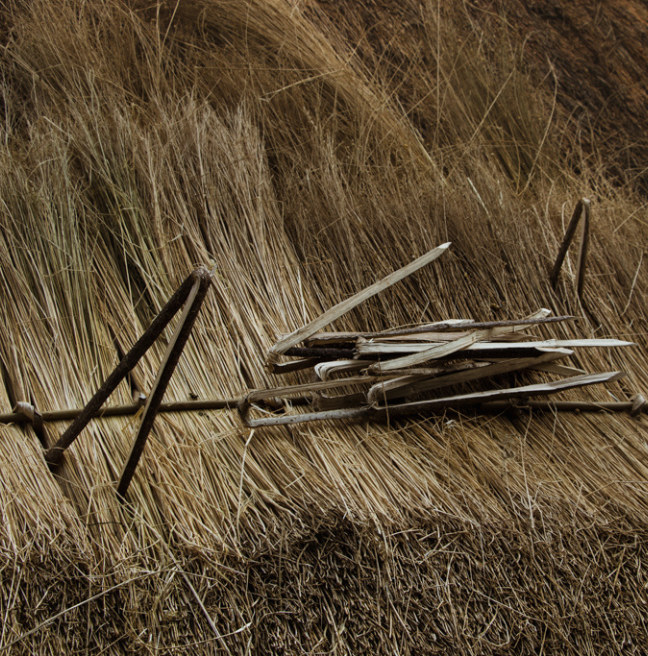 Close up of a thatched roof and thatching pins