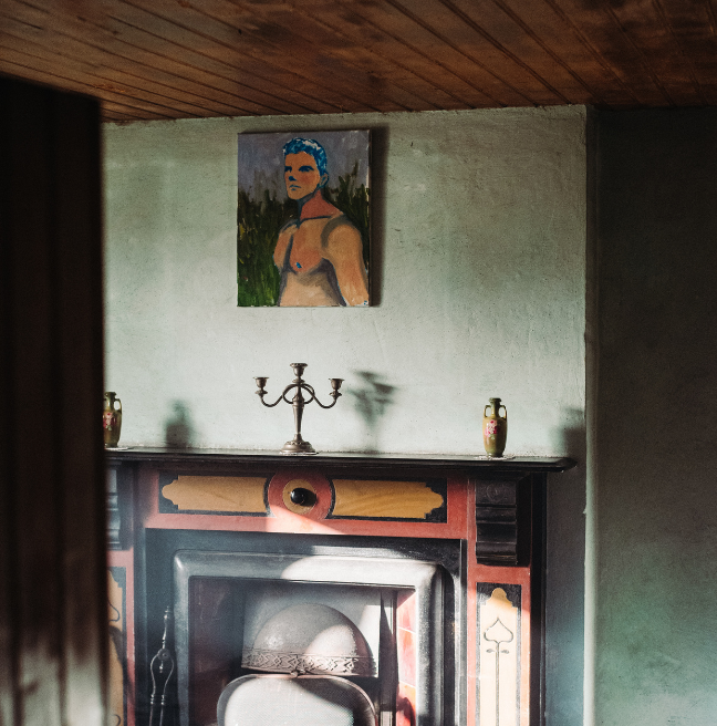 Portrait of a man hung above a fireplace