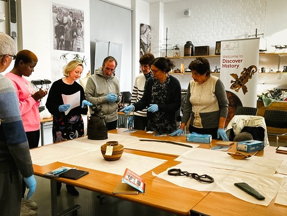 Members of the Causeway Multi Cultural Forum attending the object exploration workshop at Ulster Museum the first of 5 workshops they concluded in November 2022