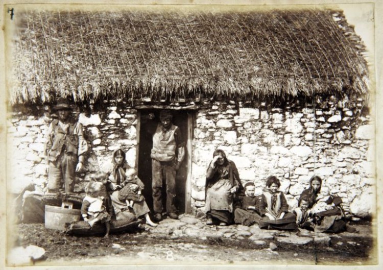 View of Gweedore dwelling with family at the door, black and white photograph