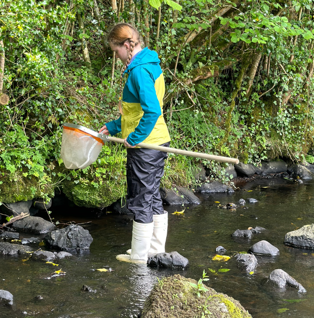 Lauren with a net in the stream