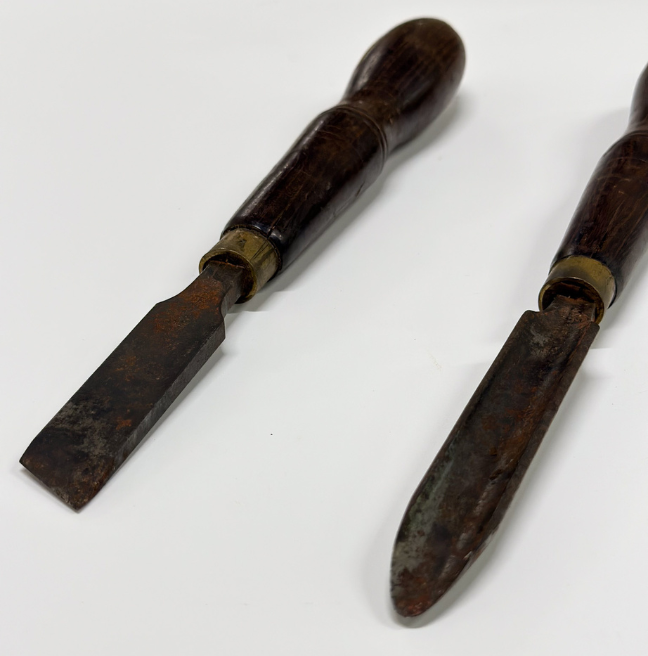 Two chisels lie side by side.