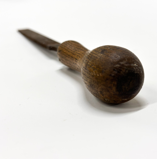 The wooden handle of a carpenter's file.