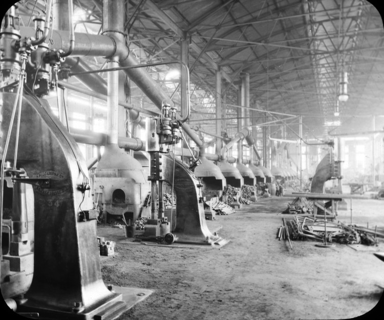A view of a shipbuilding forge, with many fires going.
