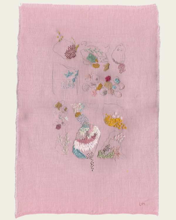On pink linen, bright threads form shapes and patterns that refernce the sea.
