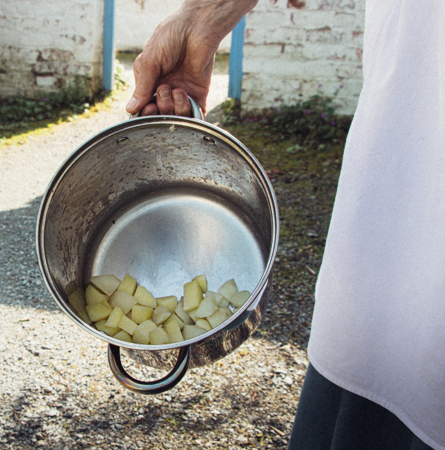 Washed and cut potatoes in a pot outside