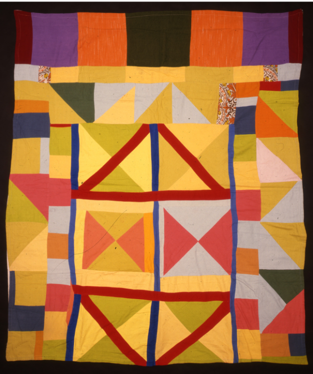 A brightly coloured quilt with diamond and square patterns.