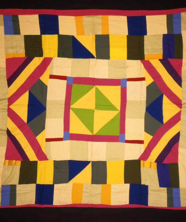 A brightly coloured quilt with a green and yellow patterned centre.