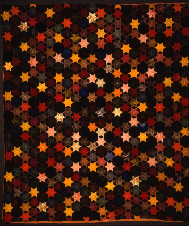 A quilt with star patterns scattered across the whole quilt.