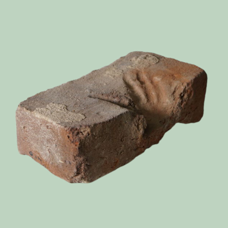 Hand print in red brick