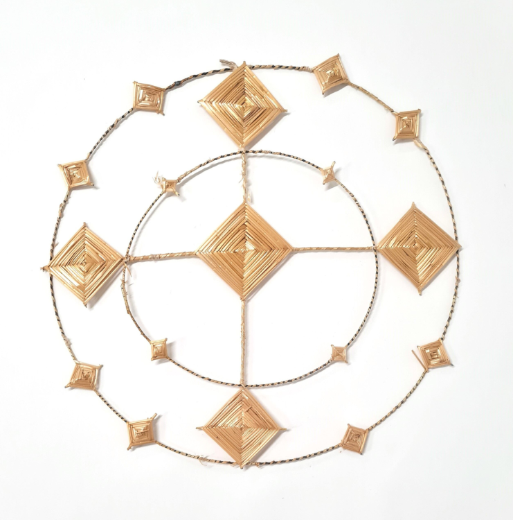 A Saint Brigid's Cross. The cross is shaped like a halo, with two rings around a diamond shaped centre.