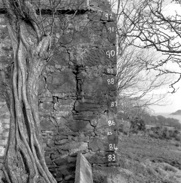 A black and white photograph of a farm building with its bricks numbered.