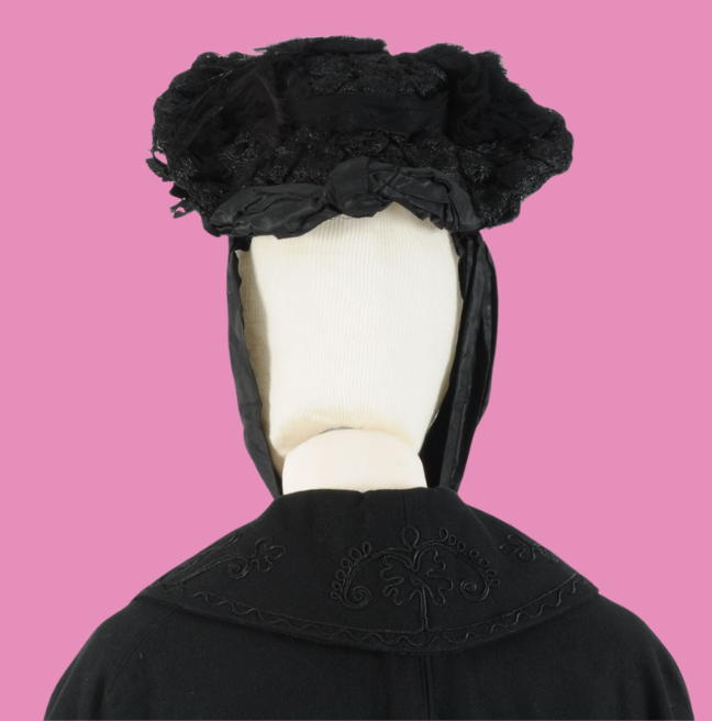 Black hat and cape on a pink background