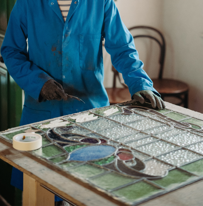 A person doing stained glass making 