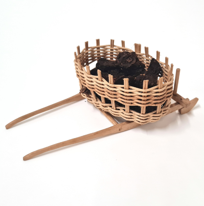 Dolls' house furniture: a wicker basket holding turf.