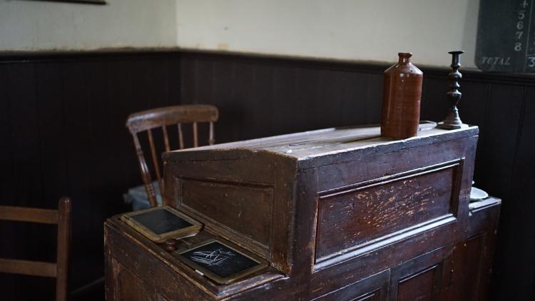 The teacher's wooden desk in an old schoolhouse.