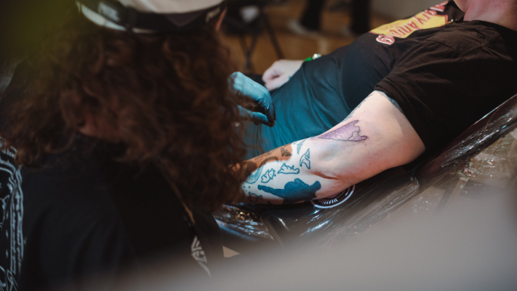 Close up of someone getting a tattoo on the inside of their arm.