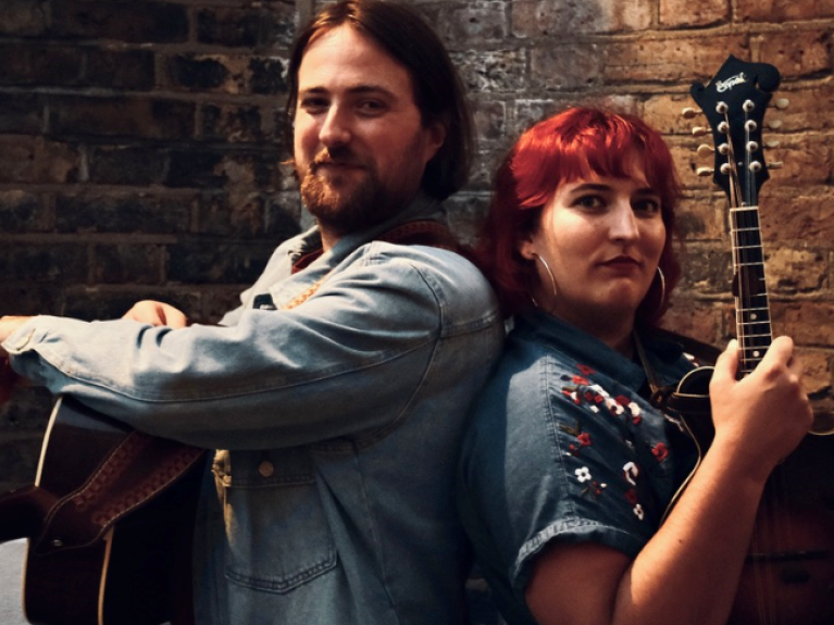 a dark haired man and red haired woman as part of Green Tree band