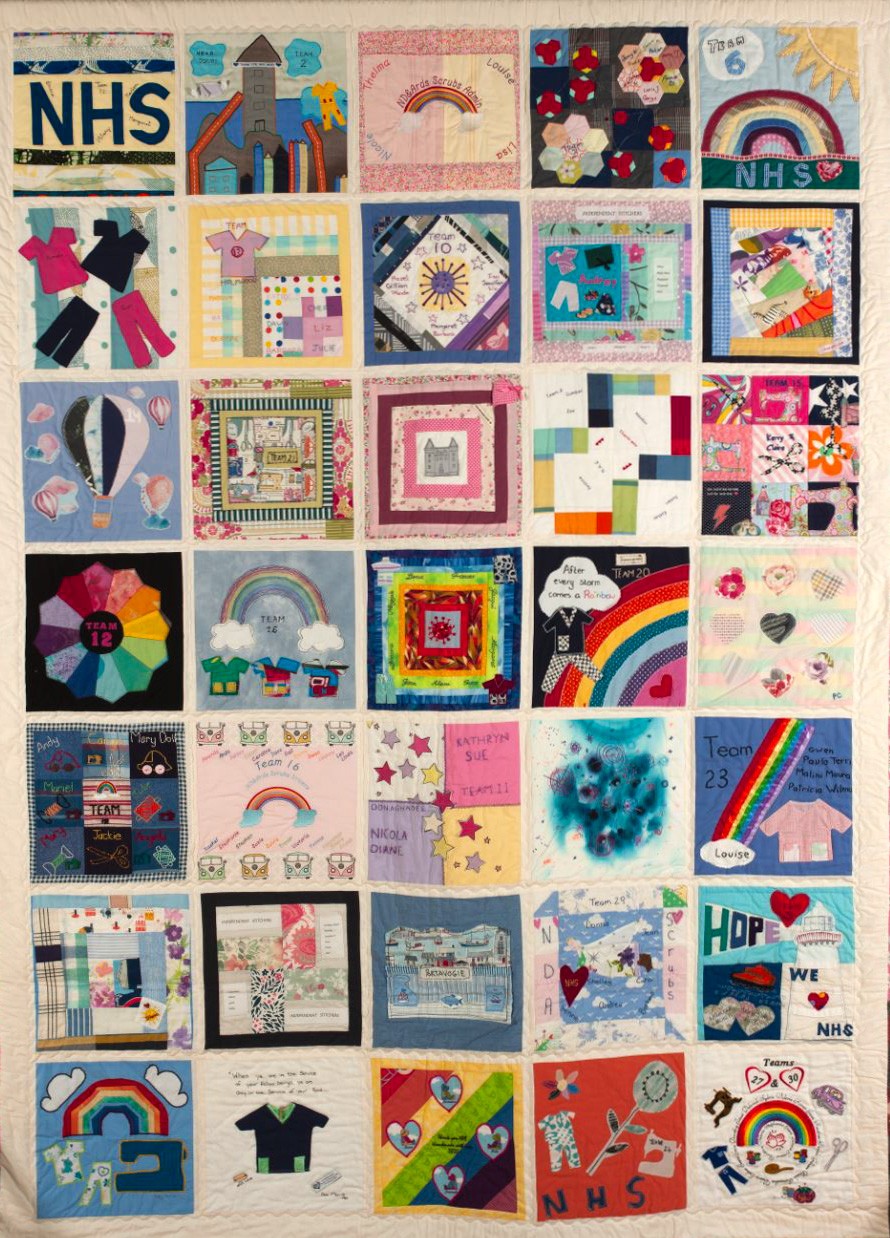 An NHS quilt, with patches featuring things like rainbows and depicitions of uniforms.