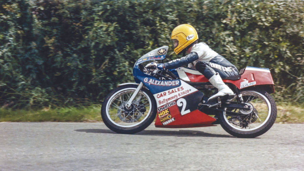 Robert Dunlo racing on a motorcycle in Joey Dunlops yellow helmet.