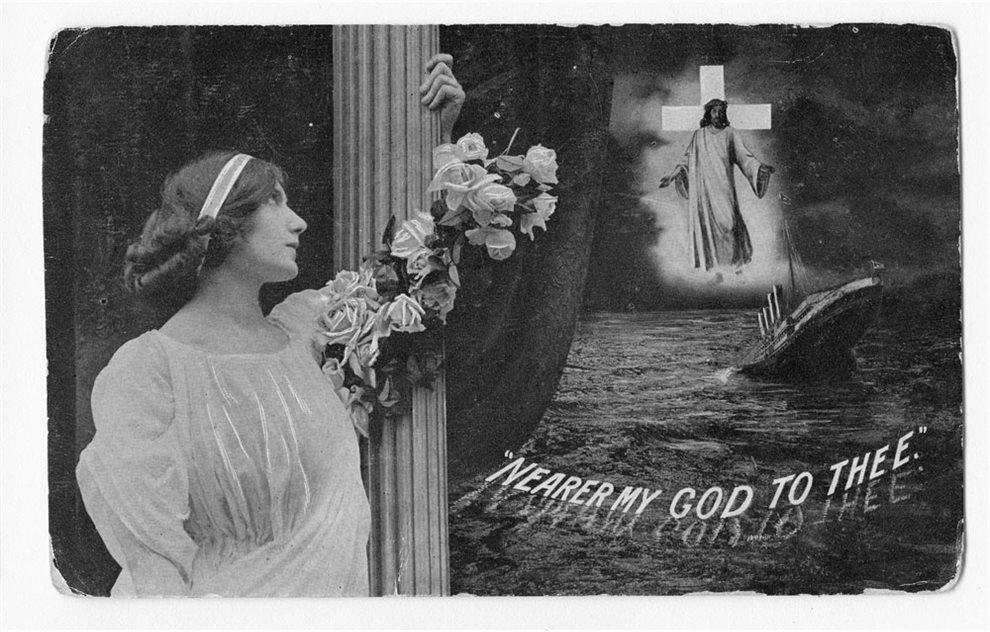 A black and white postcard from the Edwardian era. A woman gazes artistically into the distance at the image of Jesus appearing above the sinking of the Titanic. Words on the postcard read 'Nearer My God to Thee'.