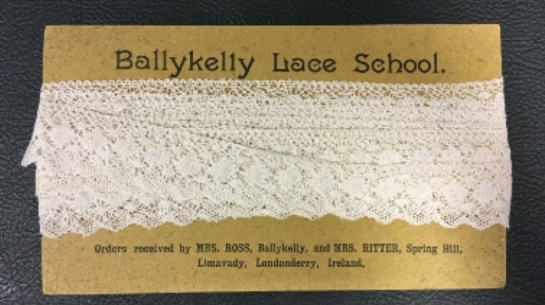 A cardboard postcard holding an example of bobbin lace from Ballykelly Lace School. 